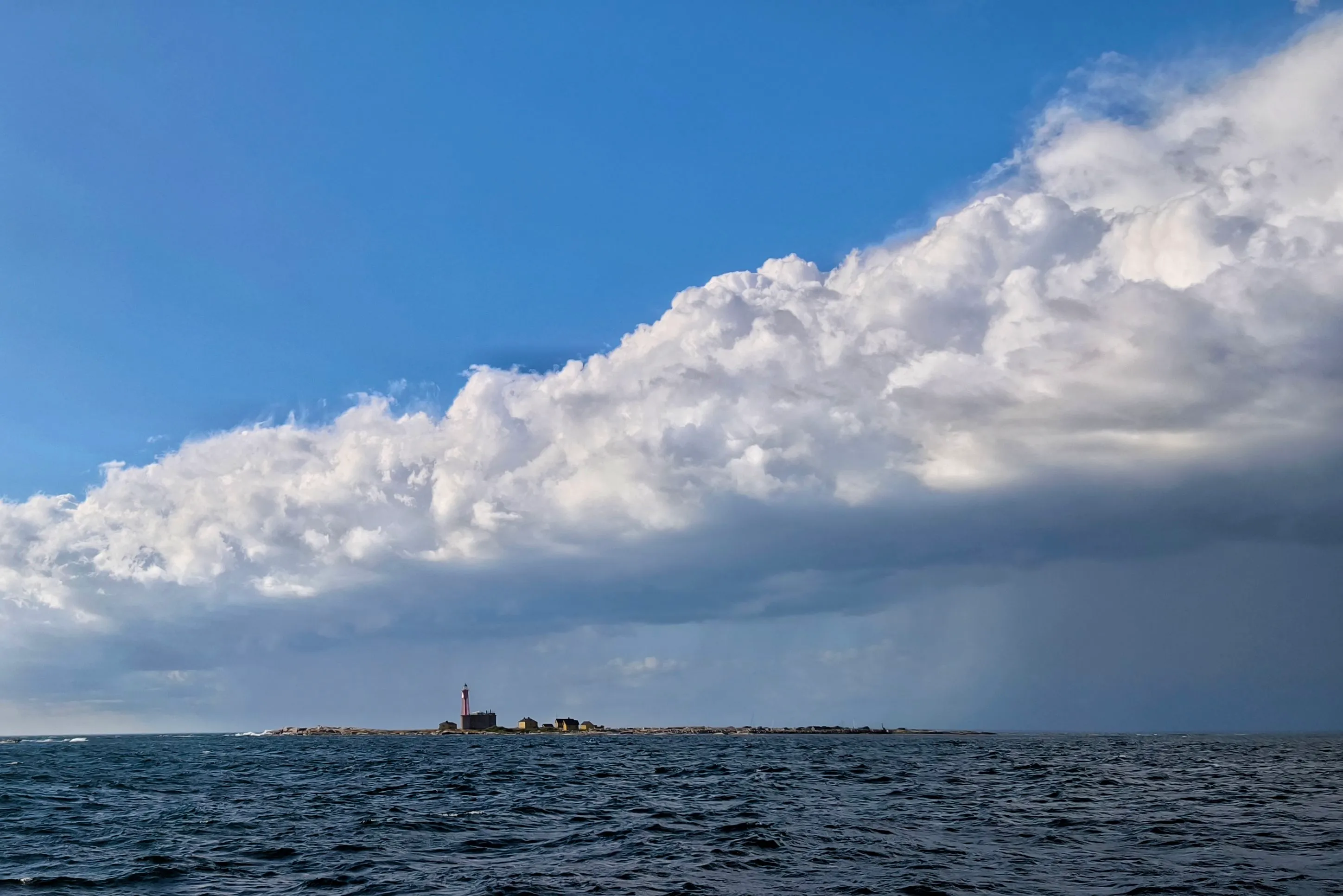 Utklippan seen from the sea with an approaching squall.
