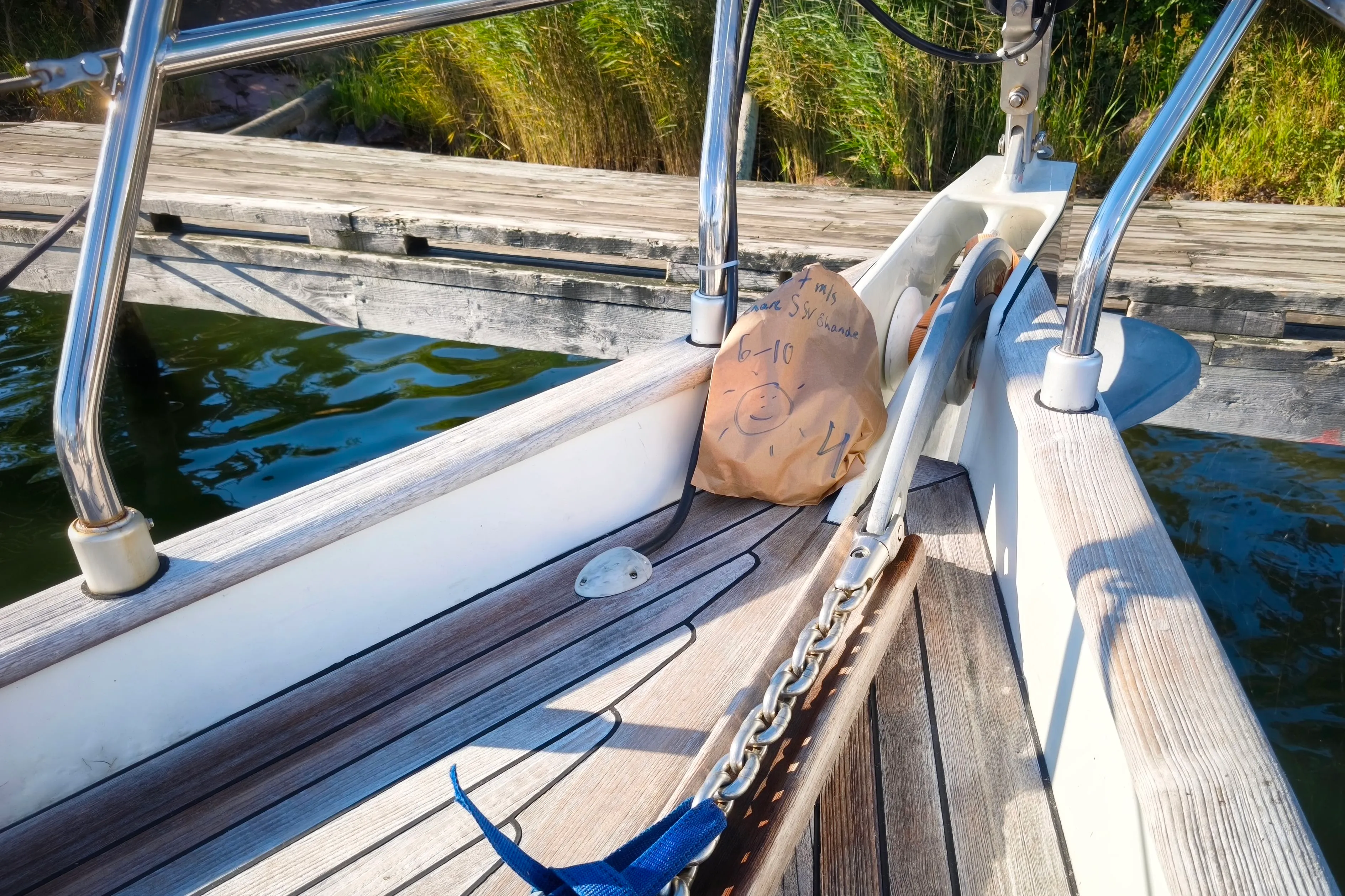 Fresh bread is delivered to the bow of the boat first thing in the morning. Weather forecasts are written on the bag. Rödhamn, Åland islands.