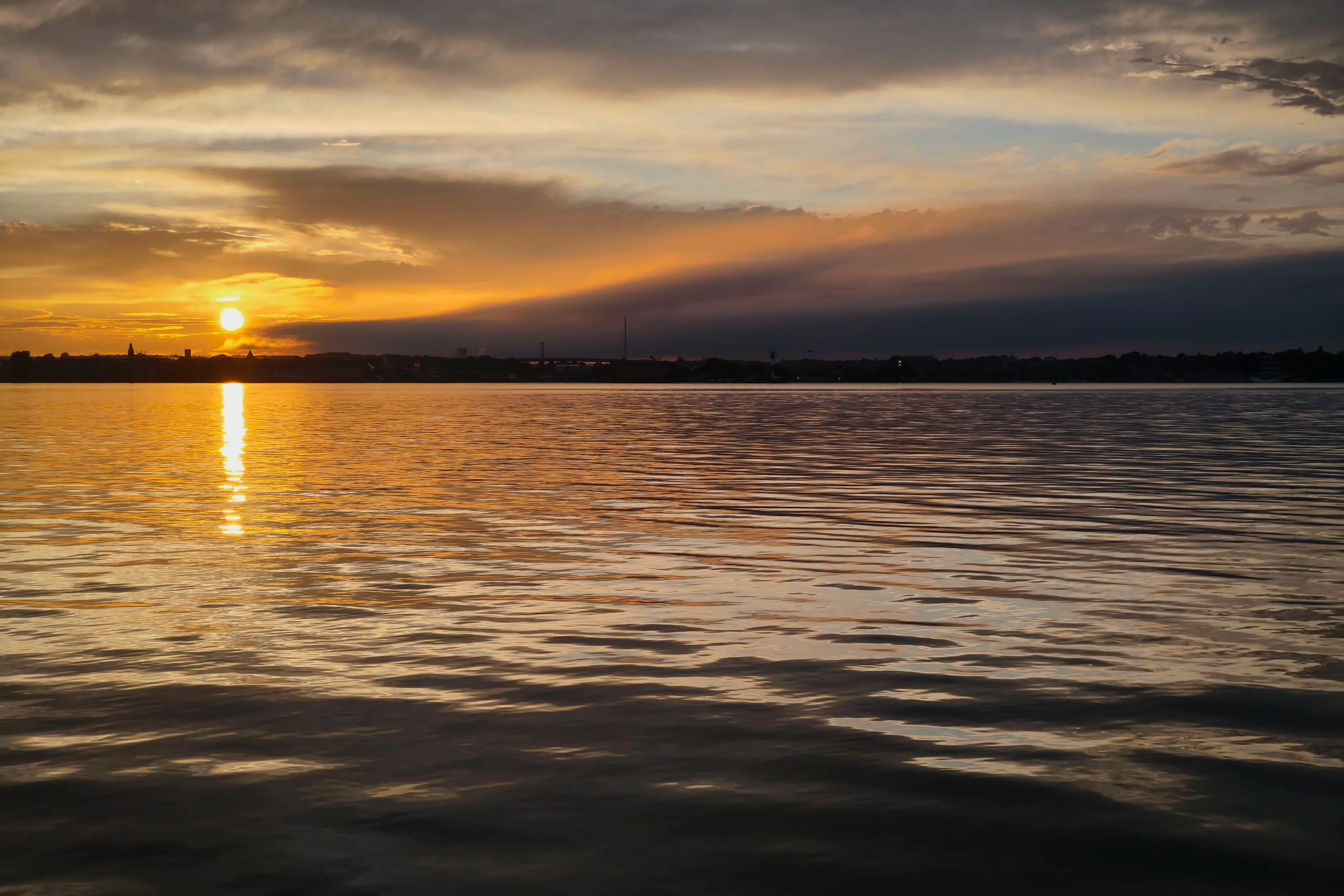 The sun sets after thunder and lightning with heavy rain had passed over Kiel, Germany.